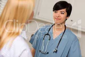 Attractive Mixed Race Young Female Doctor Talking with Patient