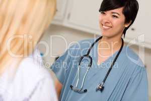 Attractive Mixed Race Young Female Doctor Talking with Patient