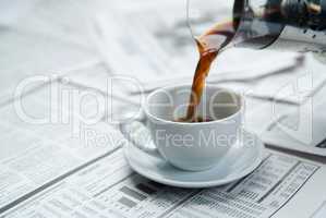 Coffee over newspaper