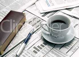 Cup of coffee on the newspaper