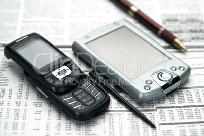 Pen, pocket, mobile on newspaper.