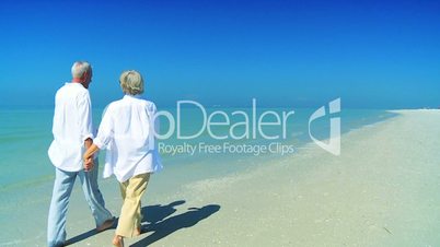 Retired Couple Barefoot on the Beach