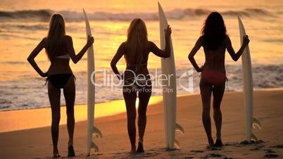 Girls With Surfboards at Sunrise