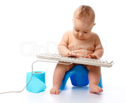 Little child is typing on keyboard