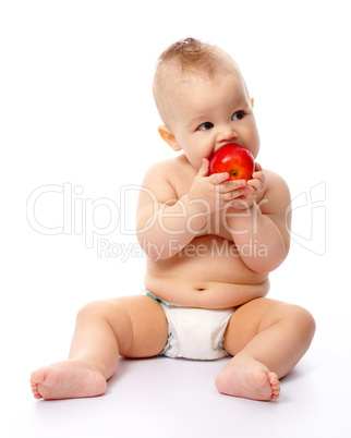 Little child is going to bite red apple