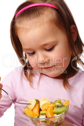 Little girl eats fruit salad