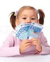 Little girl with few paper euro banknotes