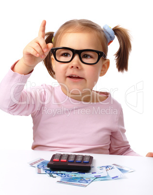 Little girl plays with money