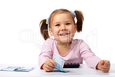 Little girl with few paper euro banknotes