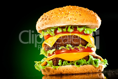 Tasty and appetizing hamburger on a darkly green
