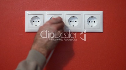 Man unplug and push electric plug into the socket
