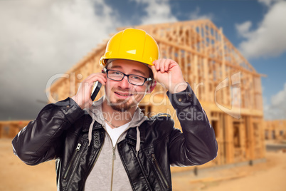 Young Cunstruction Worker on Cell Phone In Front of House