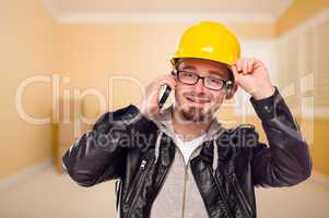 Young Contractor Wearing Hard Hat on Cell Phone In House