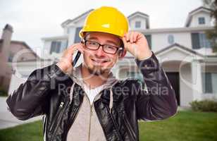 Contractor Wearing Hard Hat on Phone In Front of House