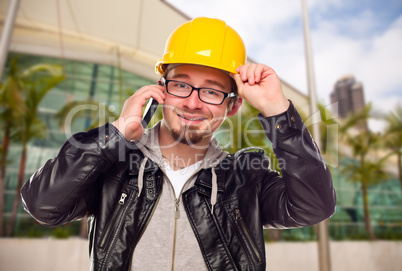 Young Cunstruction Worker on Cell Phone In Front of Building