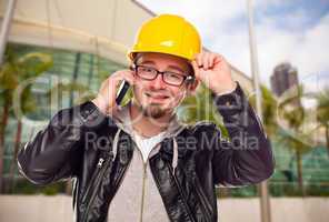 Young Cunstruction Worker on Cell Phone In Front of Building