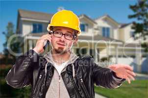 Contractor Wearing Hard Hat on Phone In Front of House