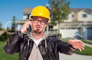 Contractor Wearing Hard Hat on Phone In Front of House