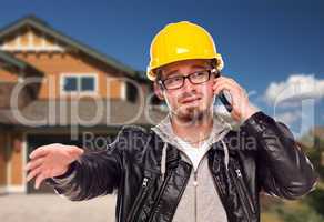 Contractor Wearing Hard Hat on Phone In Front of House