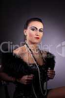 woman in fur boa with pearl beads retro syle