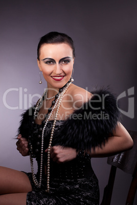 Proud woman smile in fur boa with pearl beads