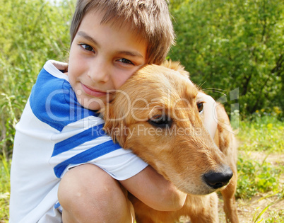 Boy hugging his dog