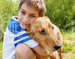 Boy hugging his dog