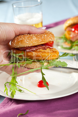 Hand holding a chickenburger