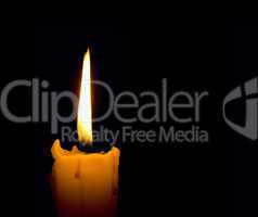 candle flame over black background with copyspace