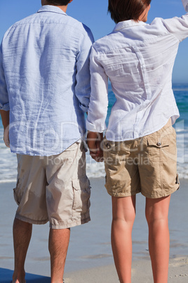 Enamored couple looking at the sea