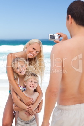 Man taking a photo of his family