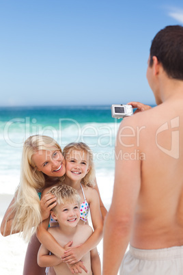 Man taking a photo of his family