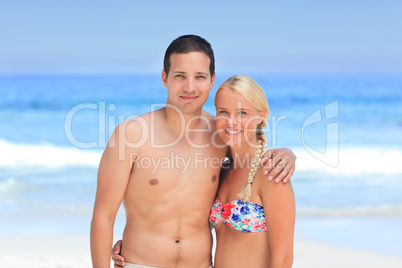 Woman huging her husband on the beach