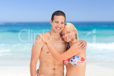 Woman huging her husband on the beach