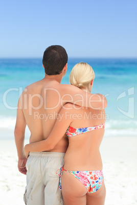 Woman huging her husband on the beach