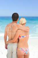 Woman huging her husband on the beach