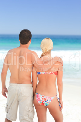 Woman huging her husband on the beach