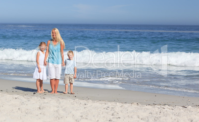 Joyful family walking on the beach