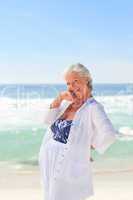 Happy retired woman on the beach