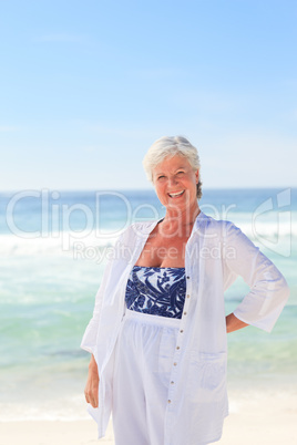 Happy retired woman on the beach