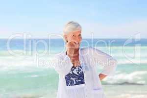 Happy retired woman on the beach