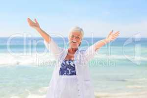 Happy retired woman on the beach