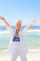 Happy retired woman on the beach