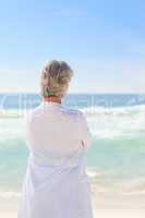 Happy retired woman on the beach