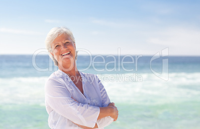 Happy retired woman on the beach