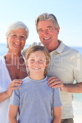 Grandparents with their grandson at the beach