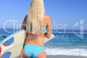 Beautiful blonde woman with her surfboard