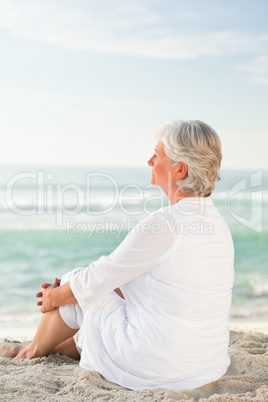 Woman who is sitting on the beach