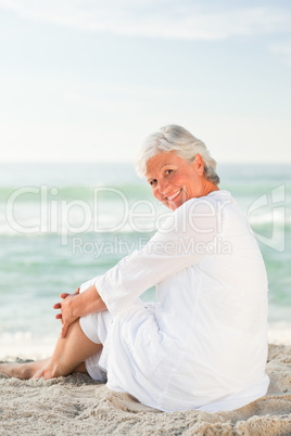 Woman who is sitting on the beach