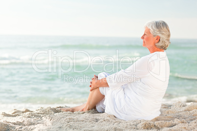 Woman who is sitting on the beach